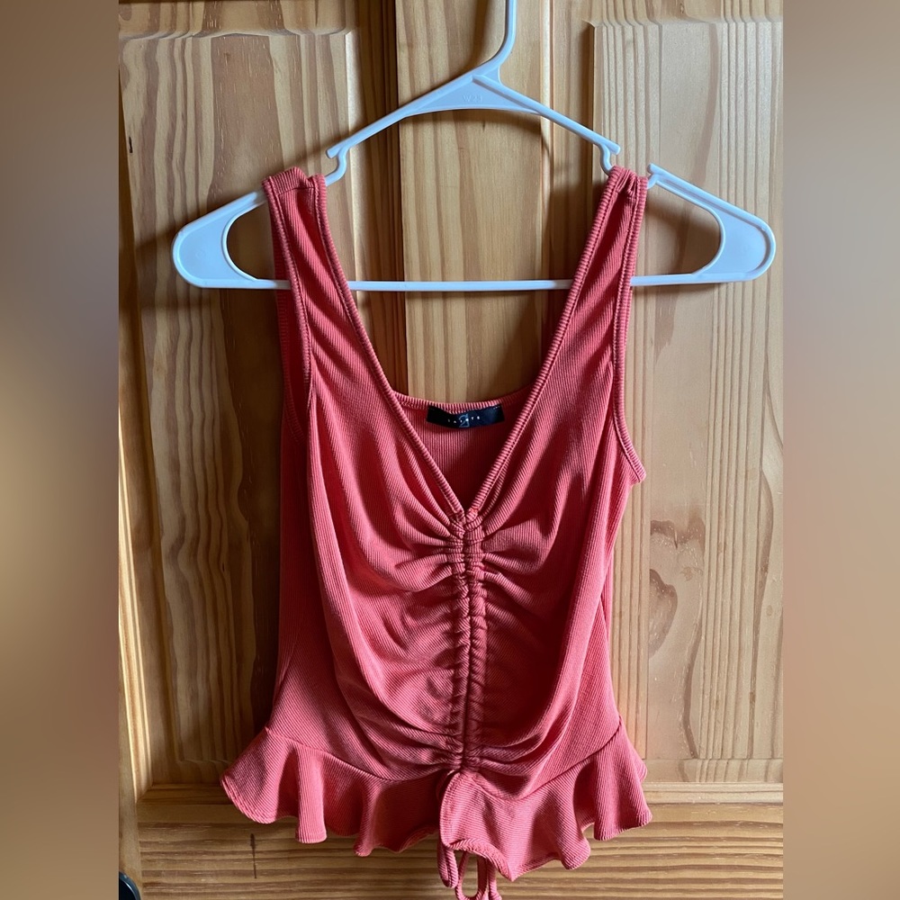 Pink tank top, size small and is made by Saints 21.